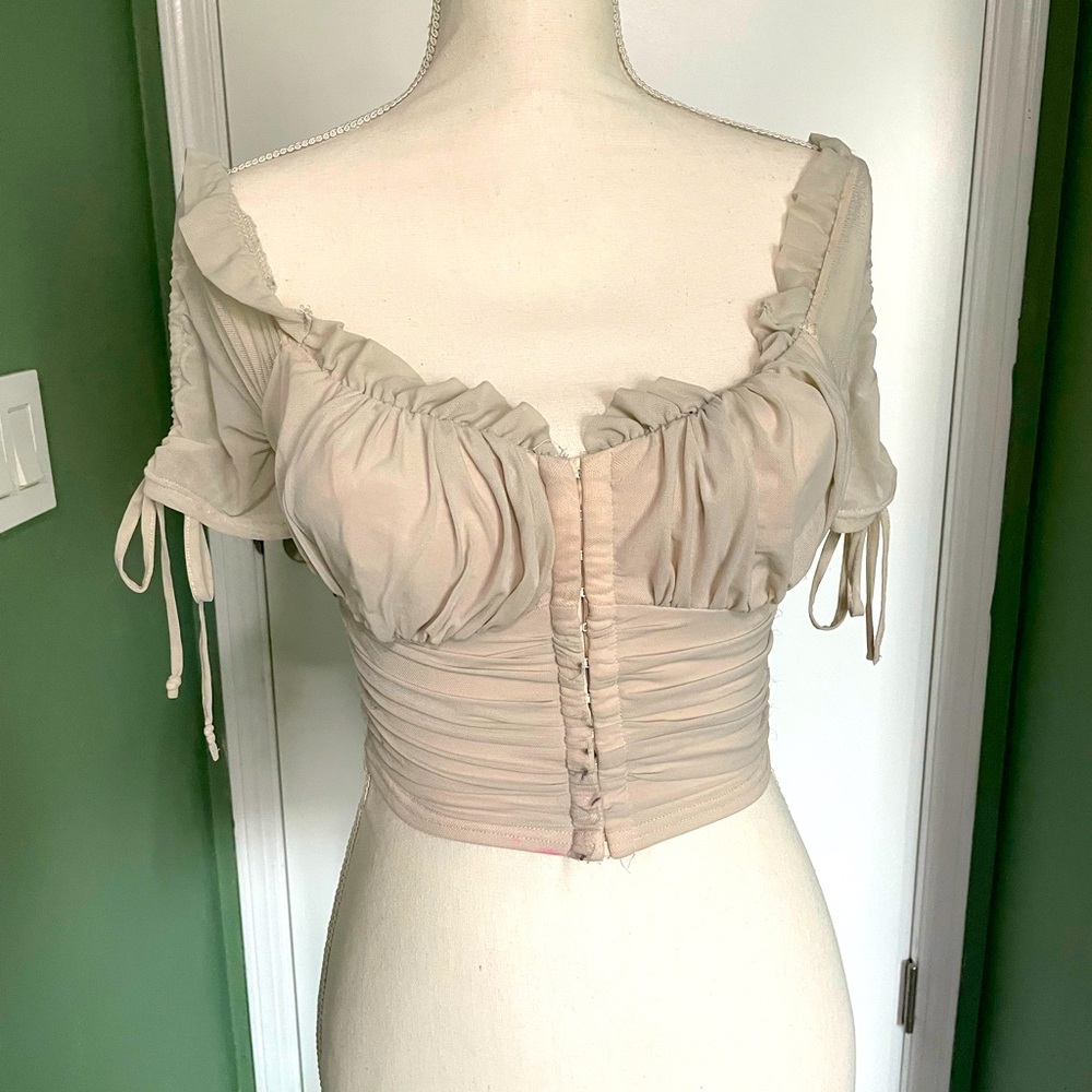 White, fitted crop top from Windsor with adjustable sleeves and front closure